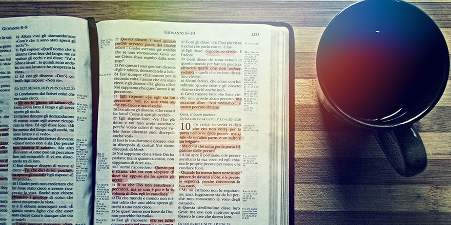 Open bible with coffee cup