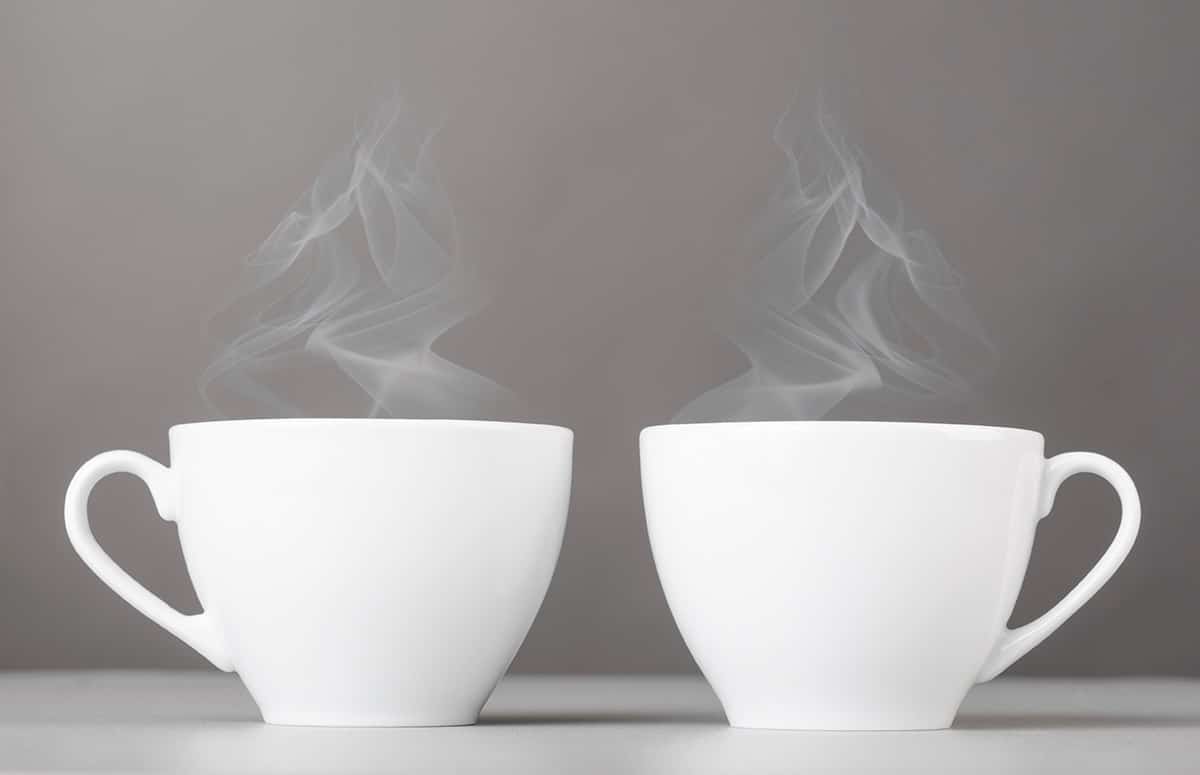 Two coffee cups steaming