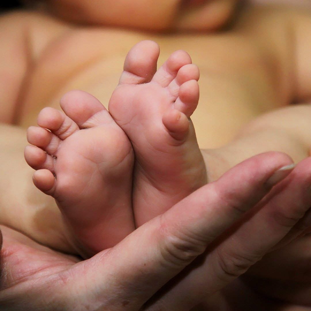 Baby feet in persons hands